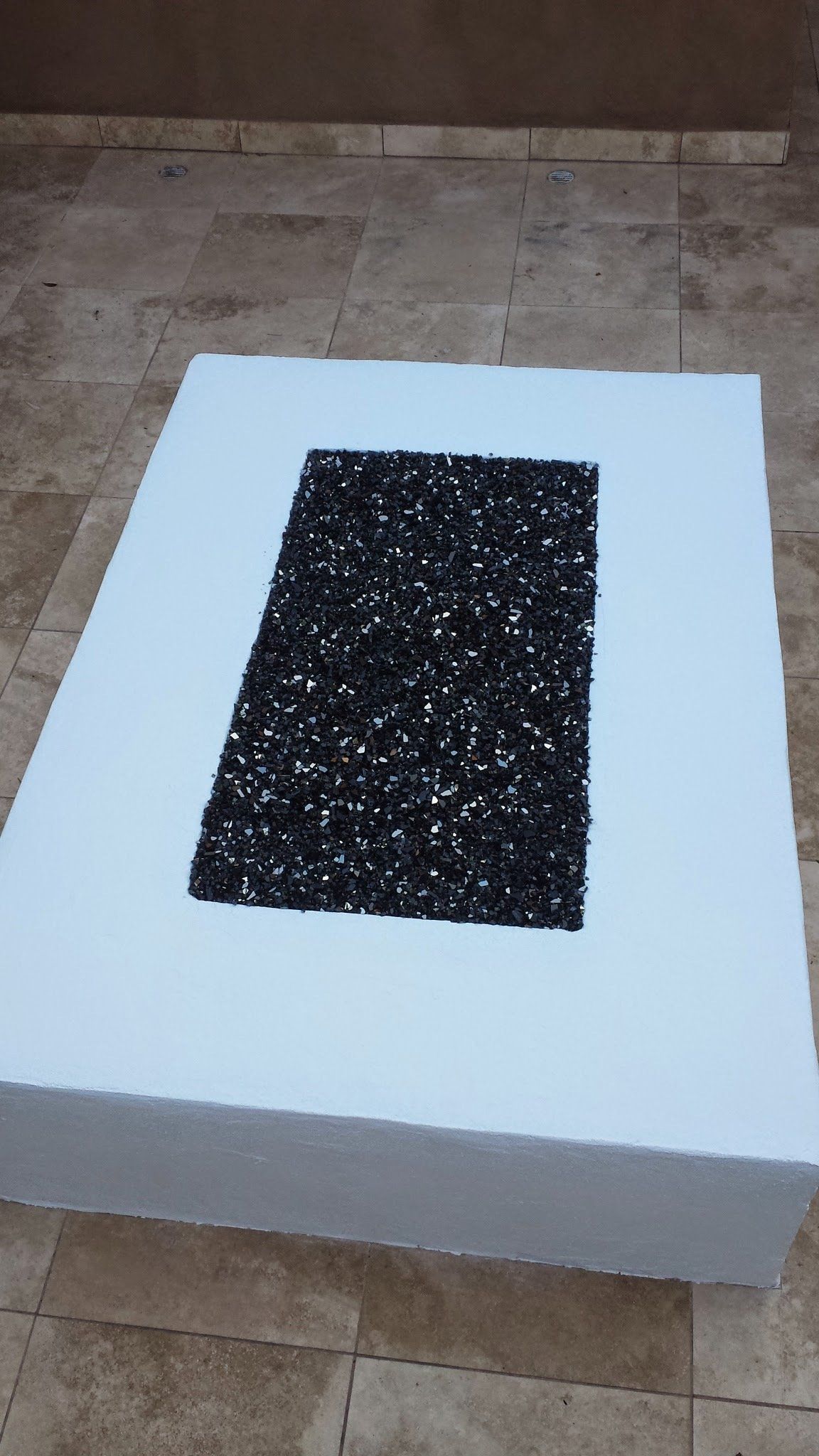 A white square with a black square in the middle