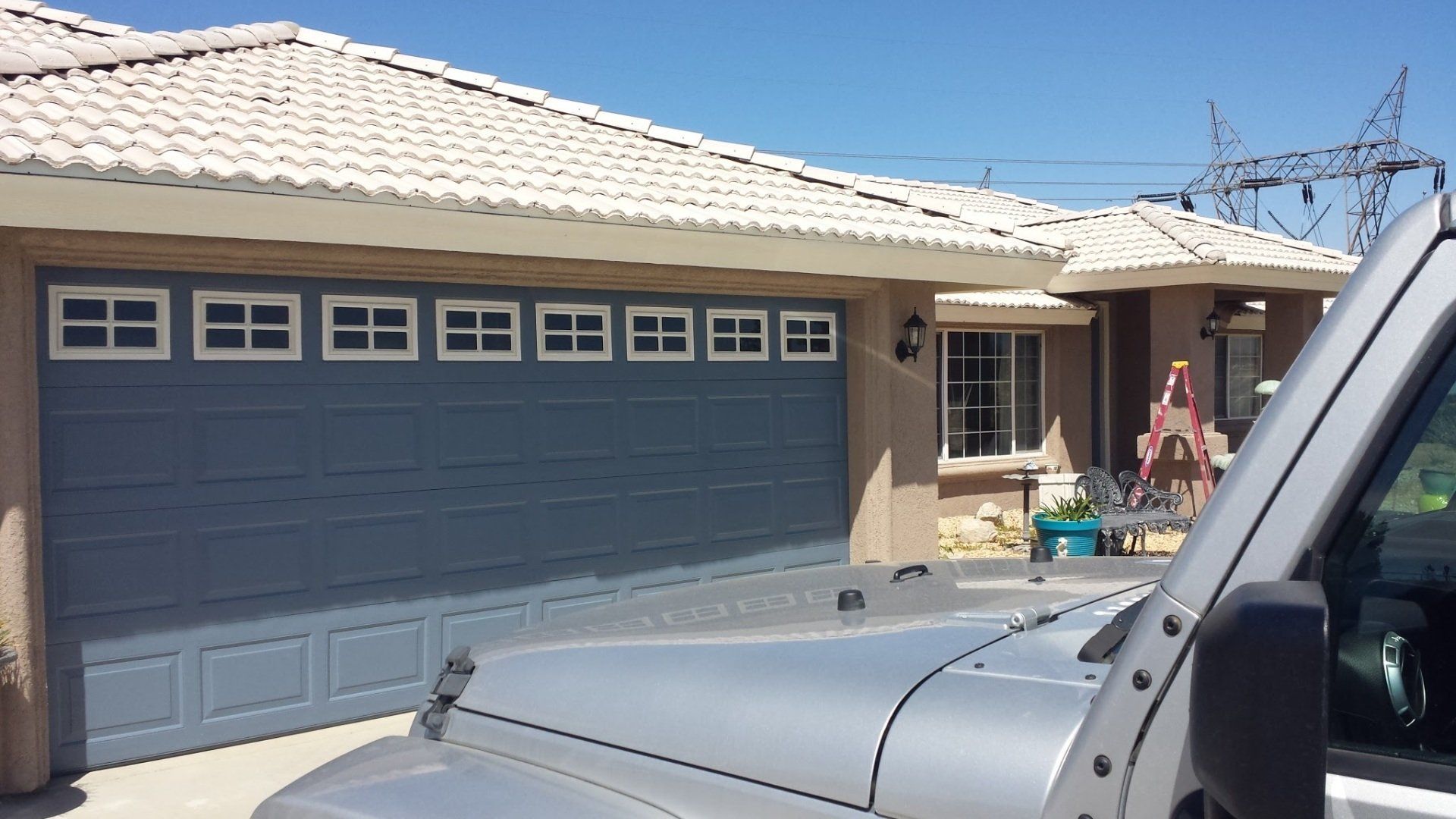 A jeep is parked in front of a garage door