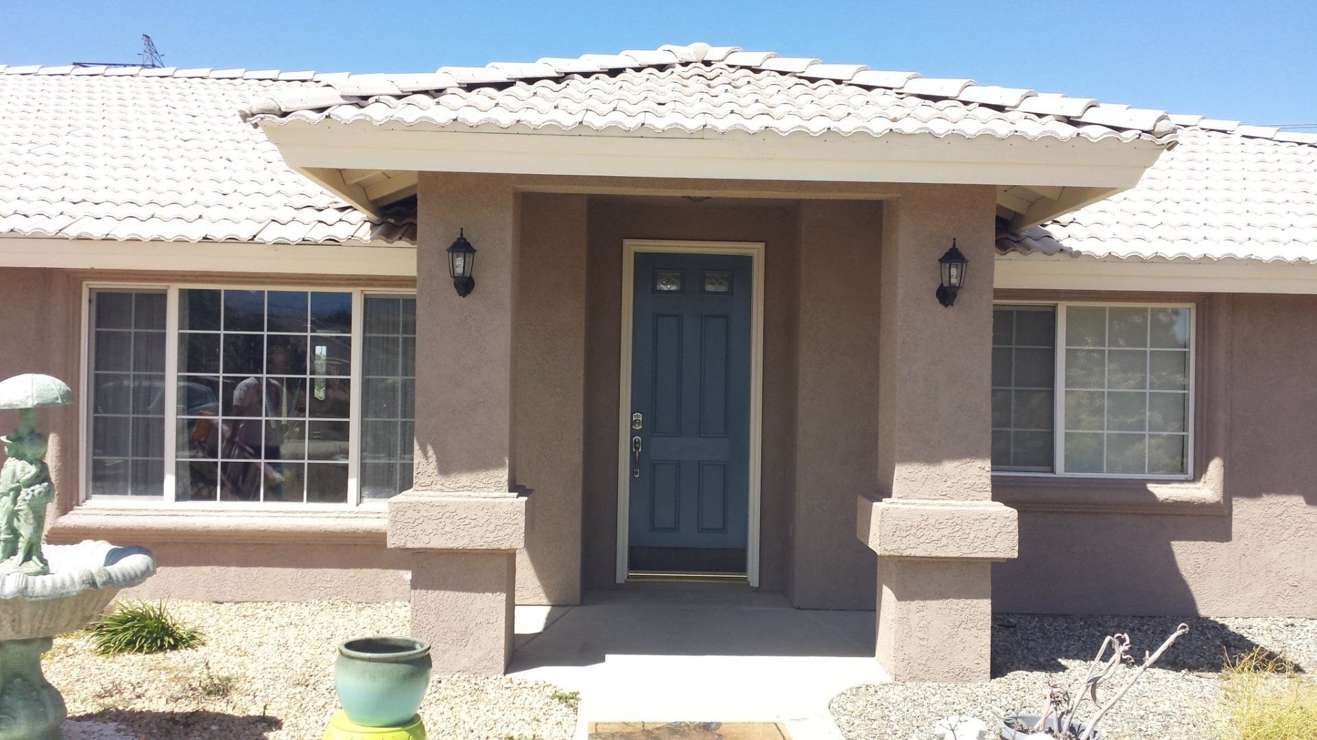 A house with a blue door and a white roof