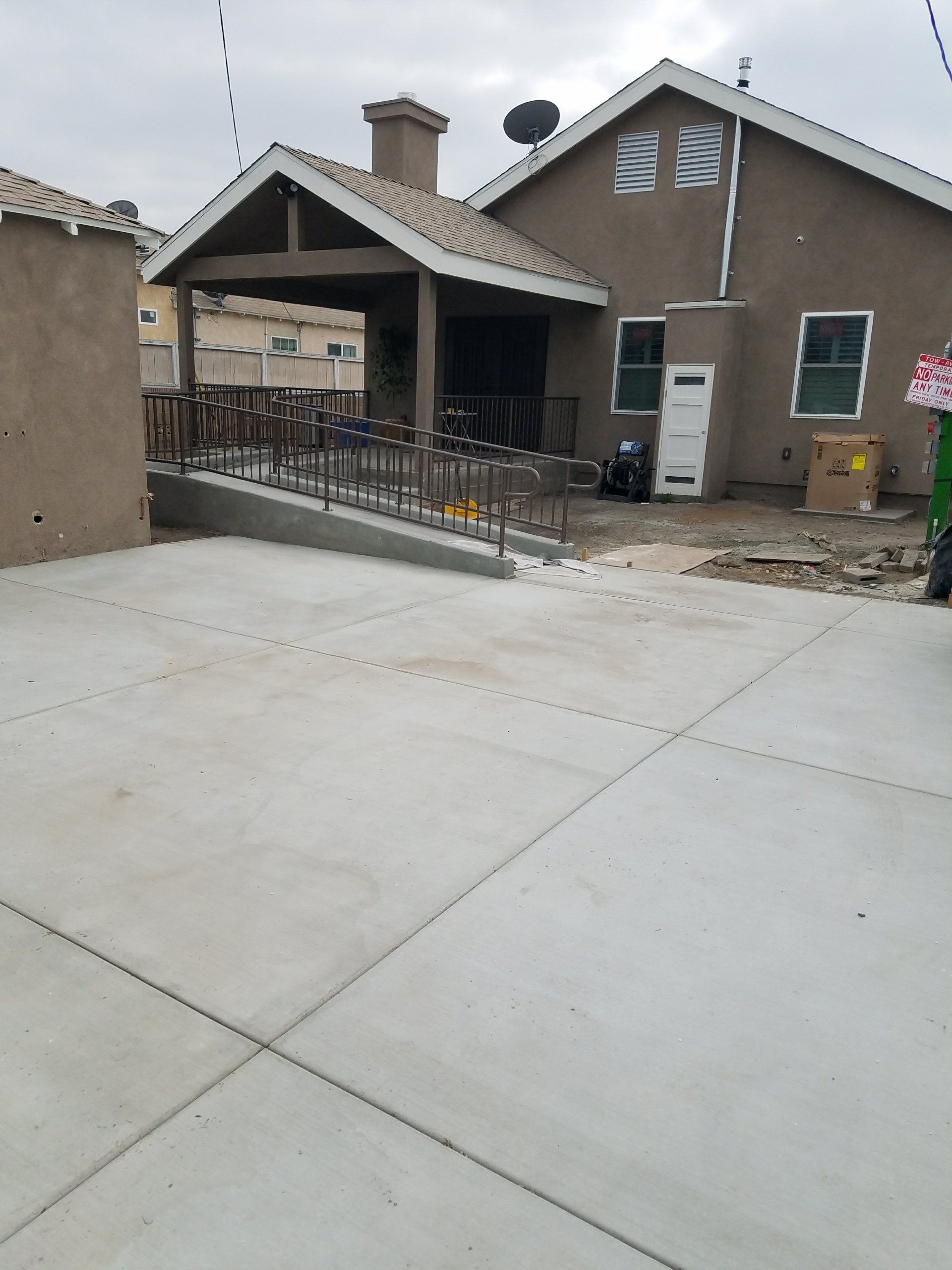 A concrete driveway leading to a house under construction