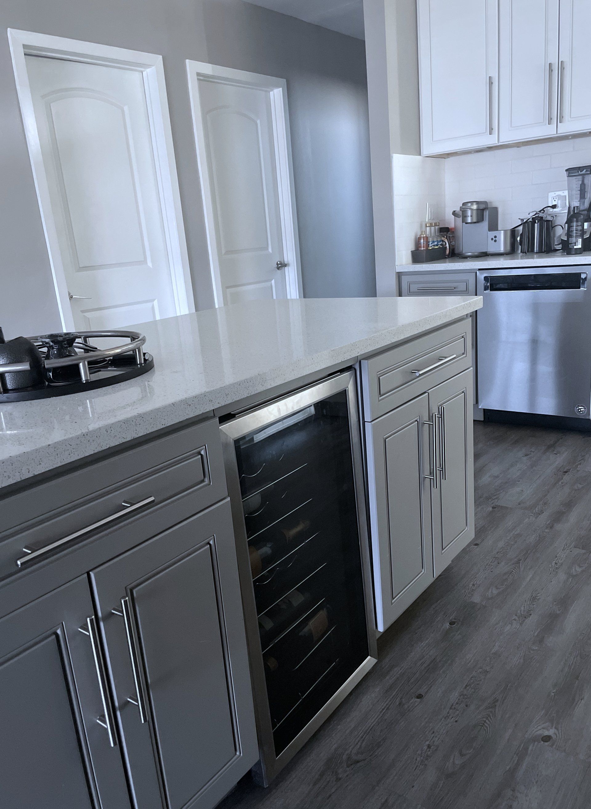 A kitchen with stainless steel appliances and a wine cooler