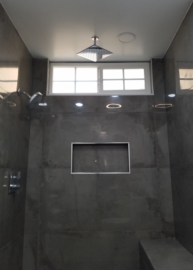 A bathroom with a window and a shower head