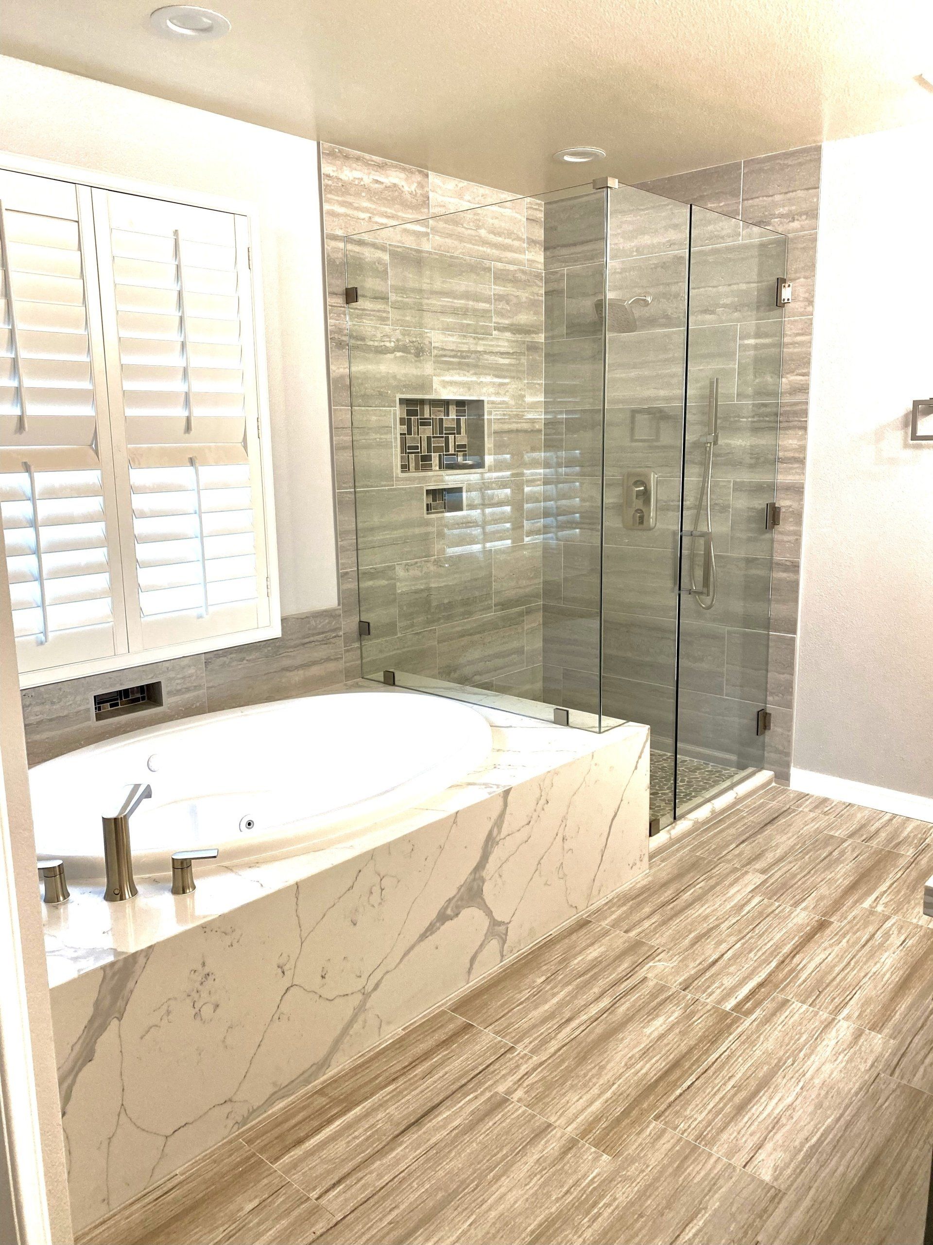 A bathroom with a bathtub and a walk in shower.