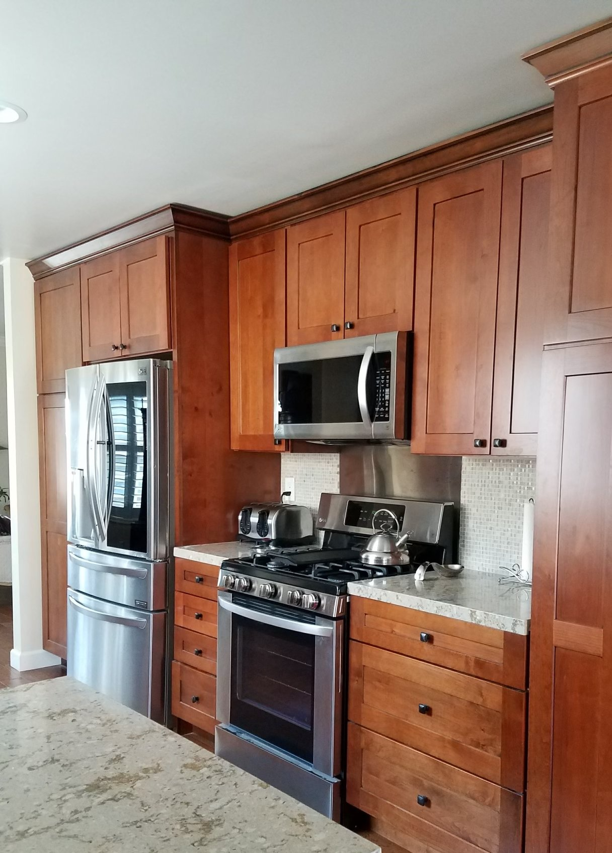A kitchen with stainless steel appliances and wooden cabinets