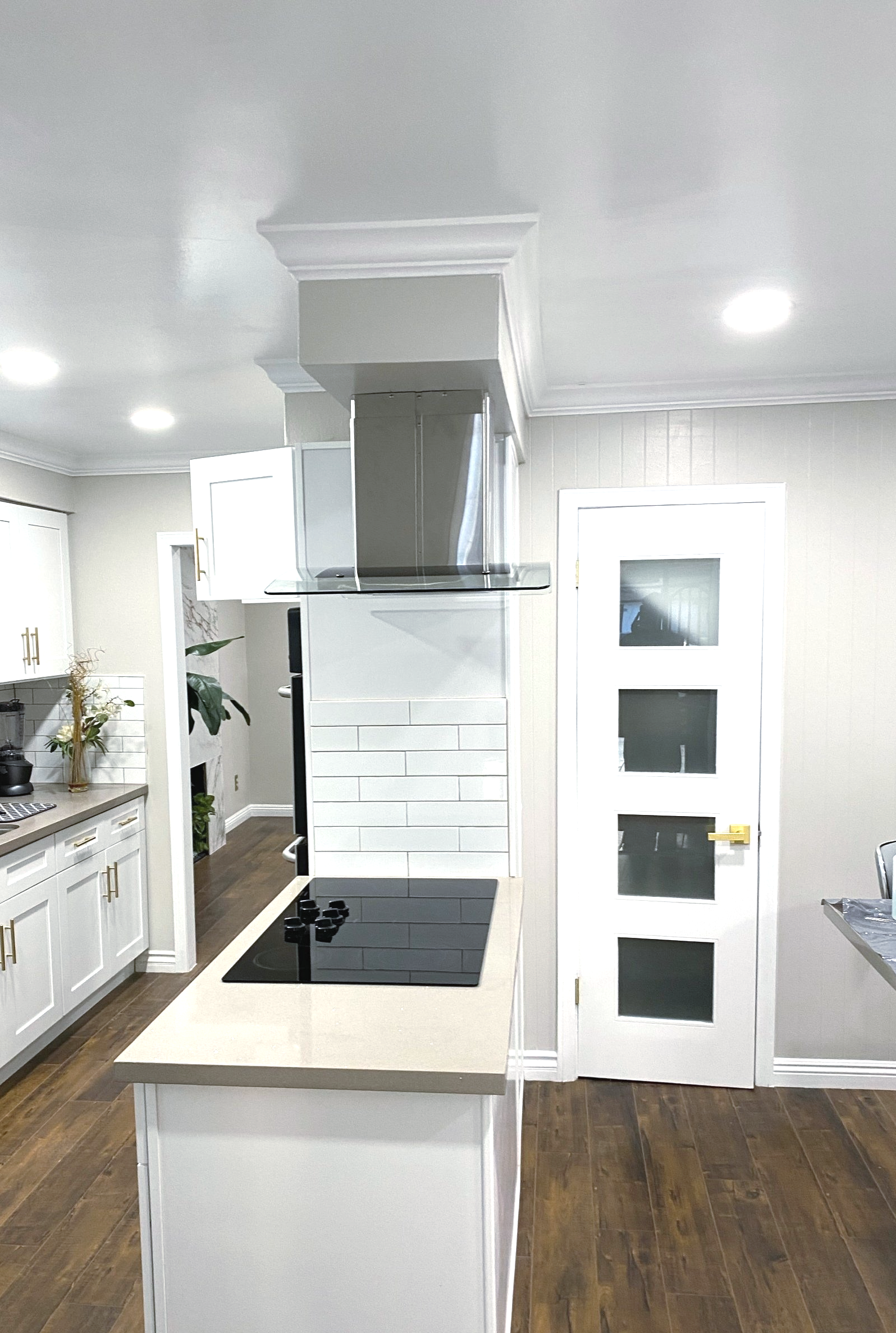 A kitchen with a large island and a stove top oven.