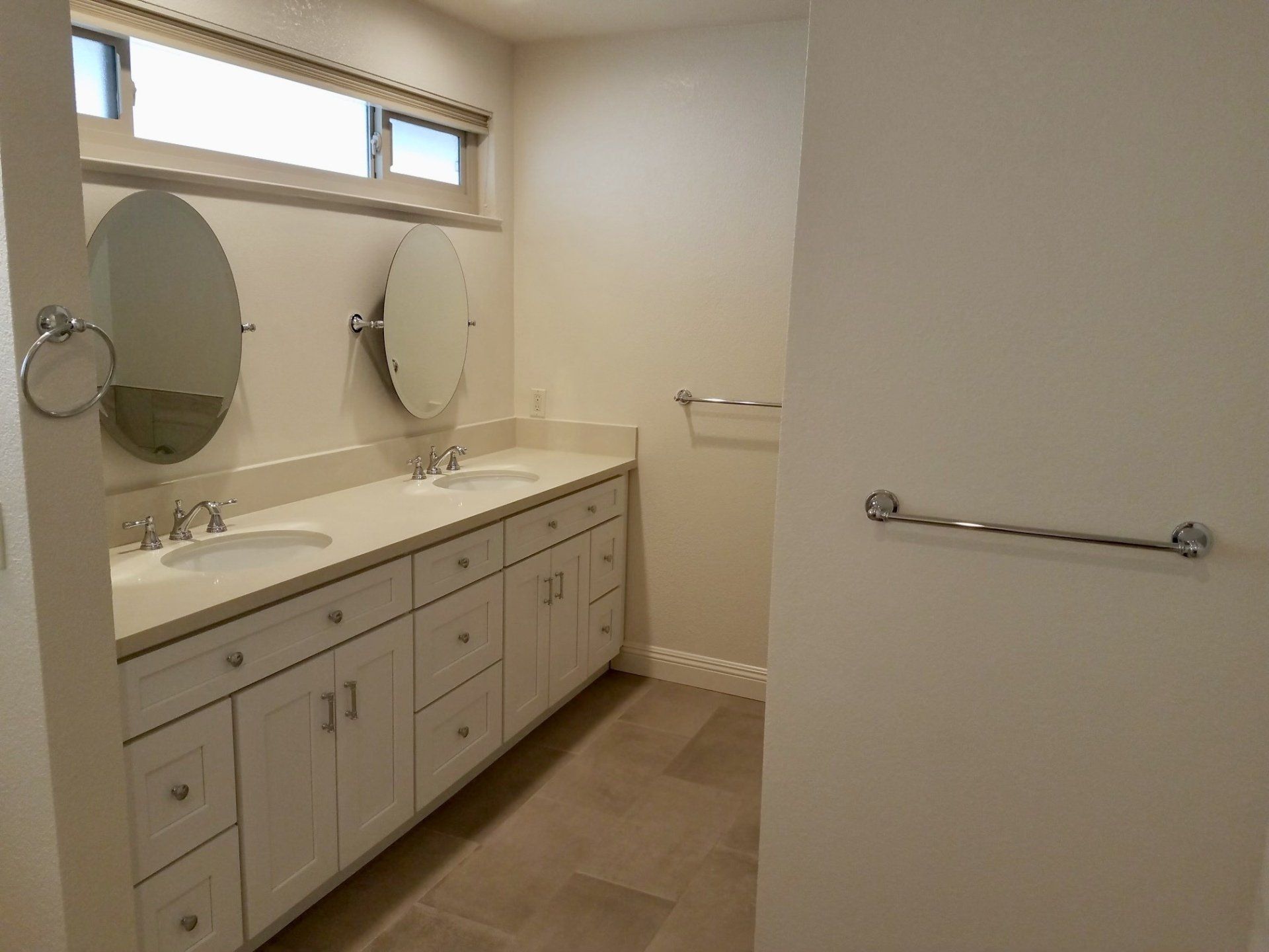 A bathroom with two sinks and two mirrors.