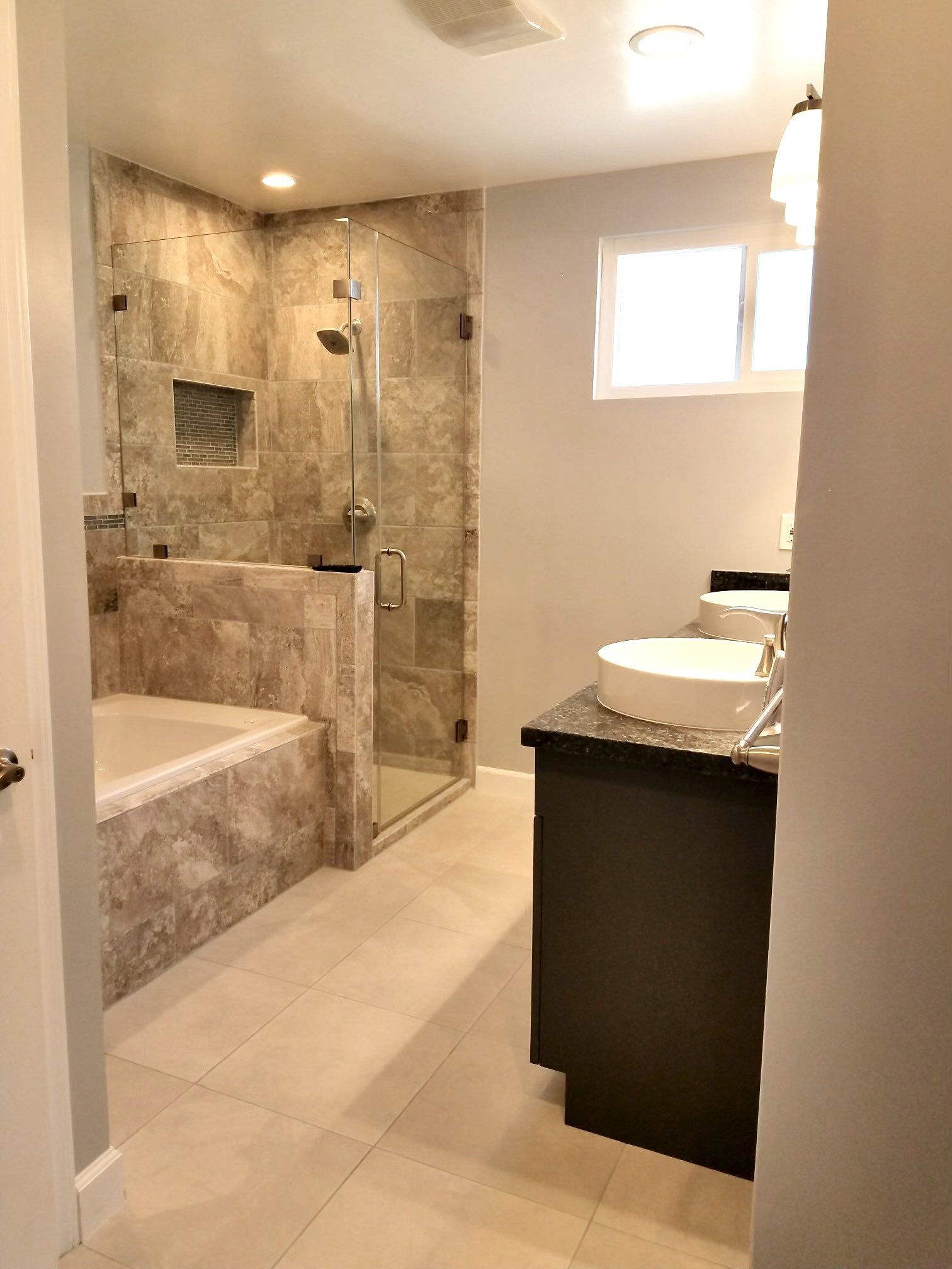 A bathroom with a tub , sink , and shower.