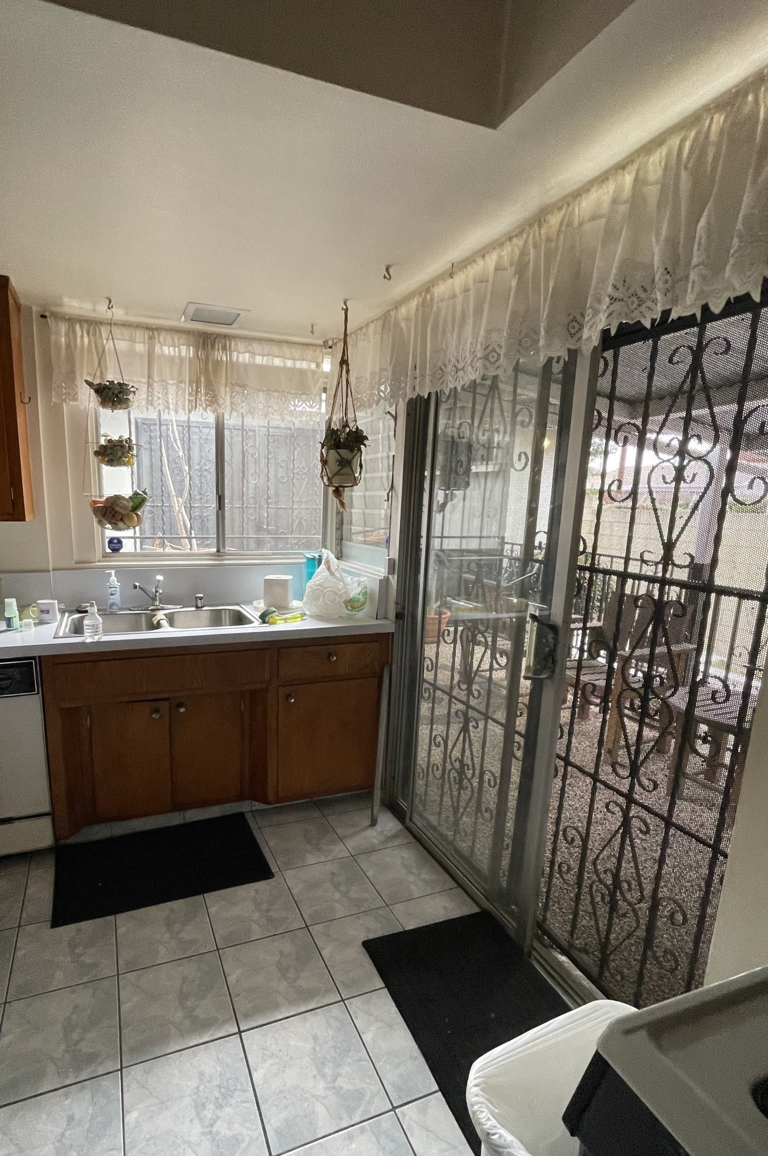 A kitchen with a sliding glass door and a sink.