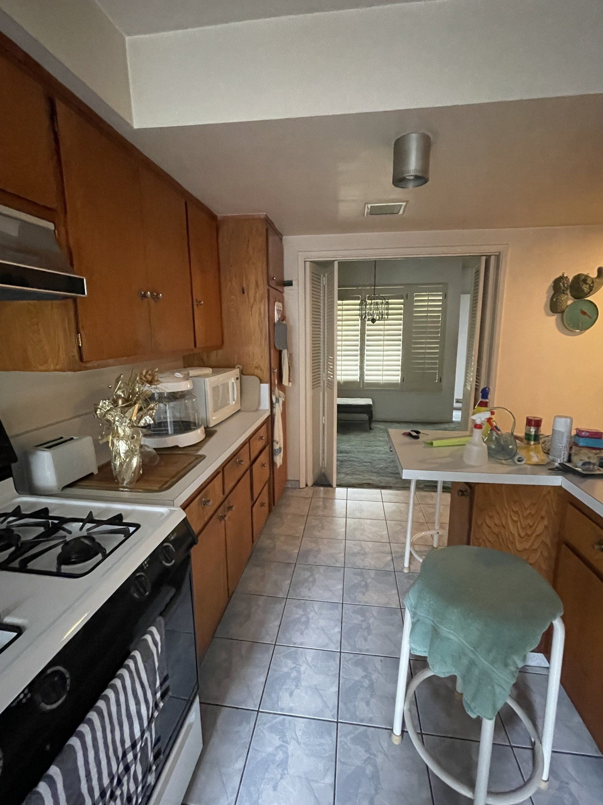 A kitchen with wooden cabinets and a stove top oven
