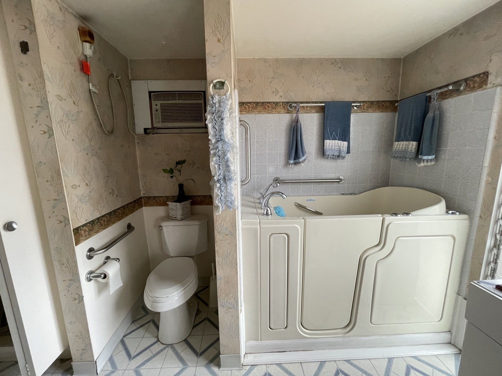 A bathroom with a walk in tub , toilet and shower.