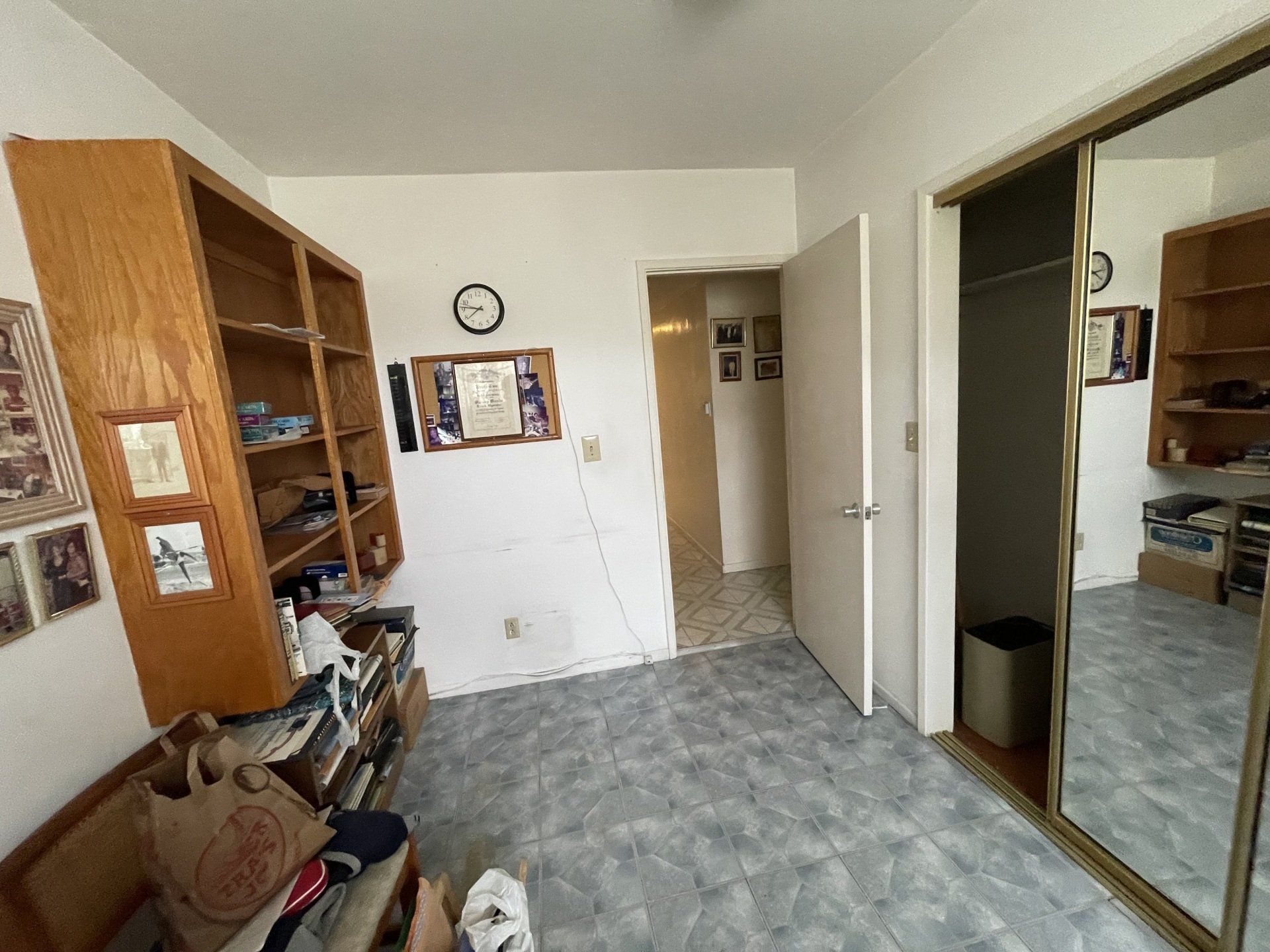 A room with a sliding glass door and a mirror.