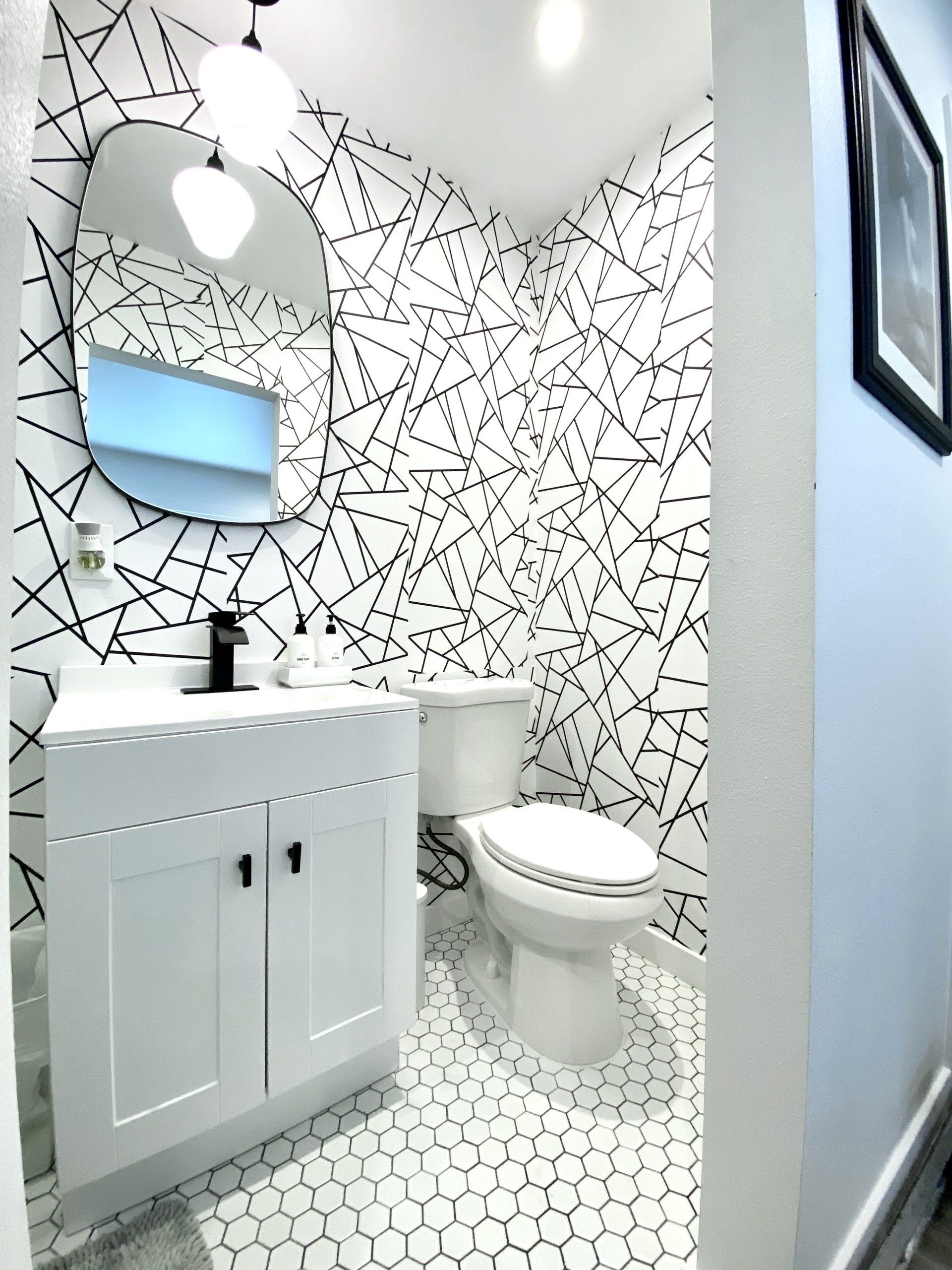 A bathroom with a toilet a sink and a mirror