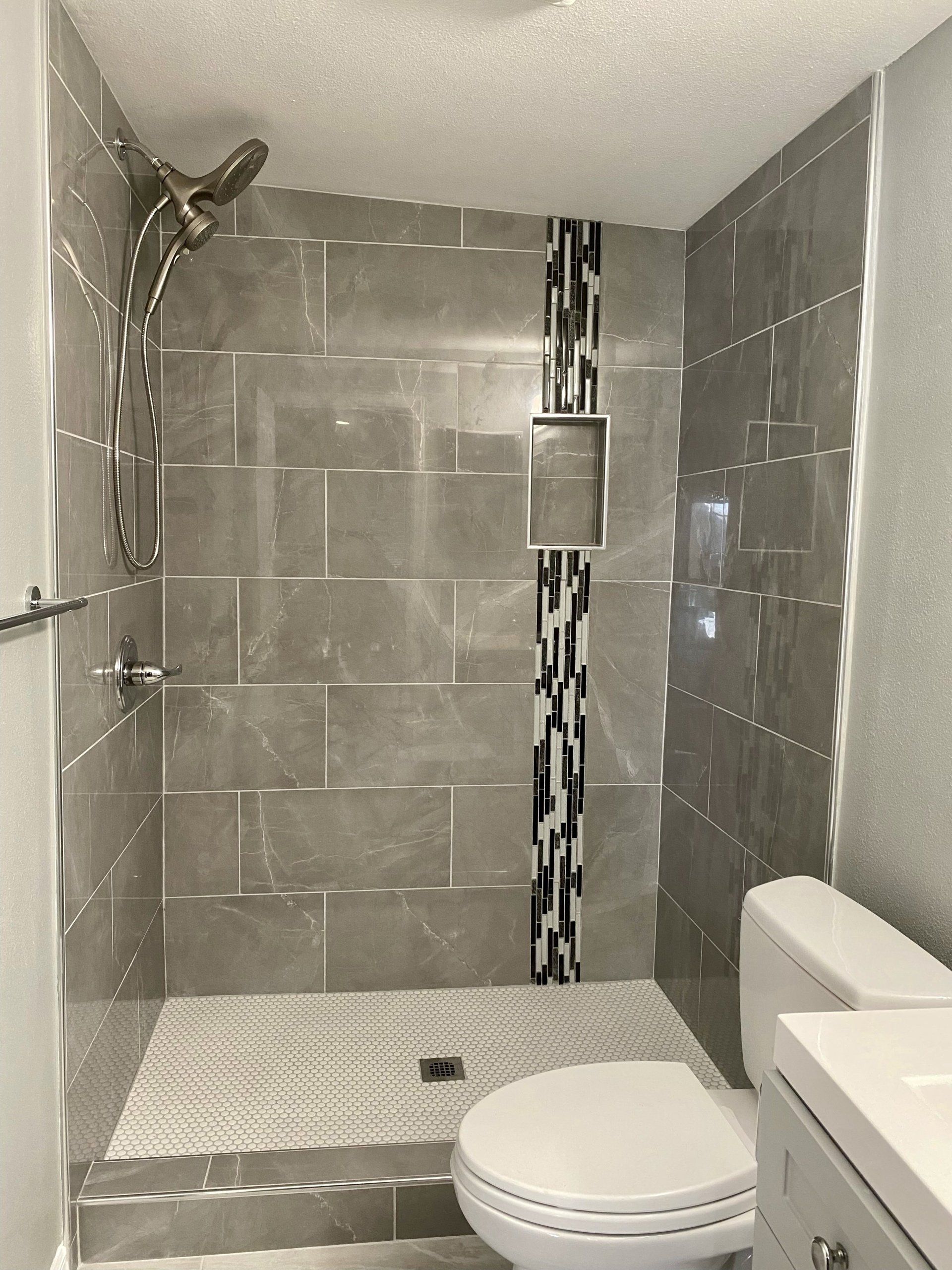 A bathroom with a walk in shower and a toilet