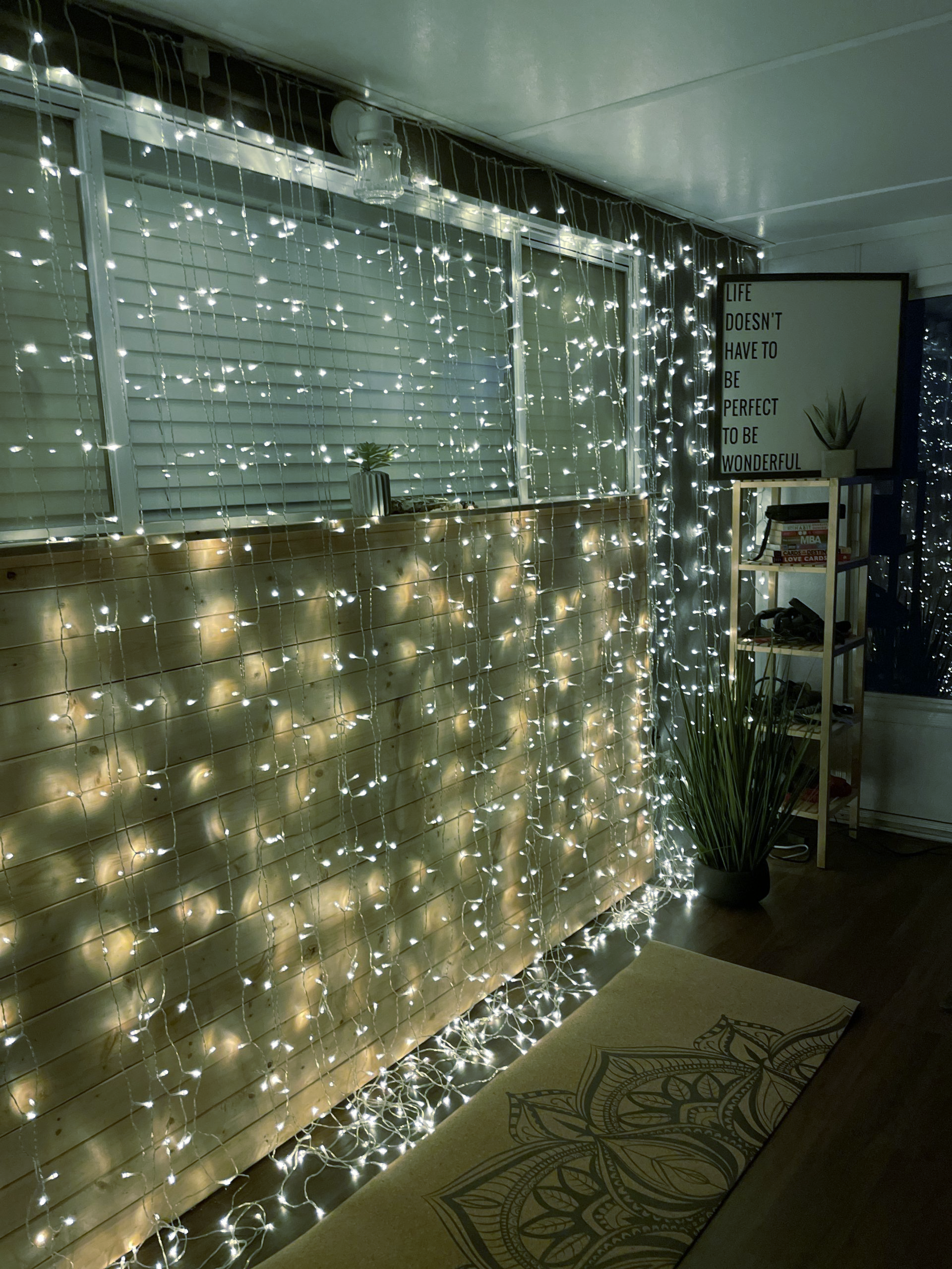 A room with a lot of christmas lights on the wall.
