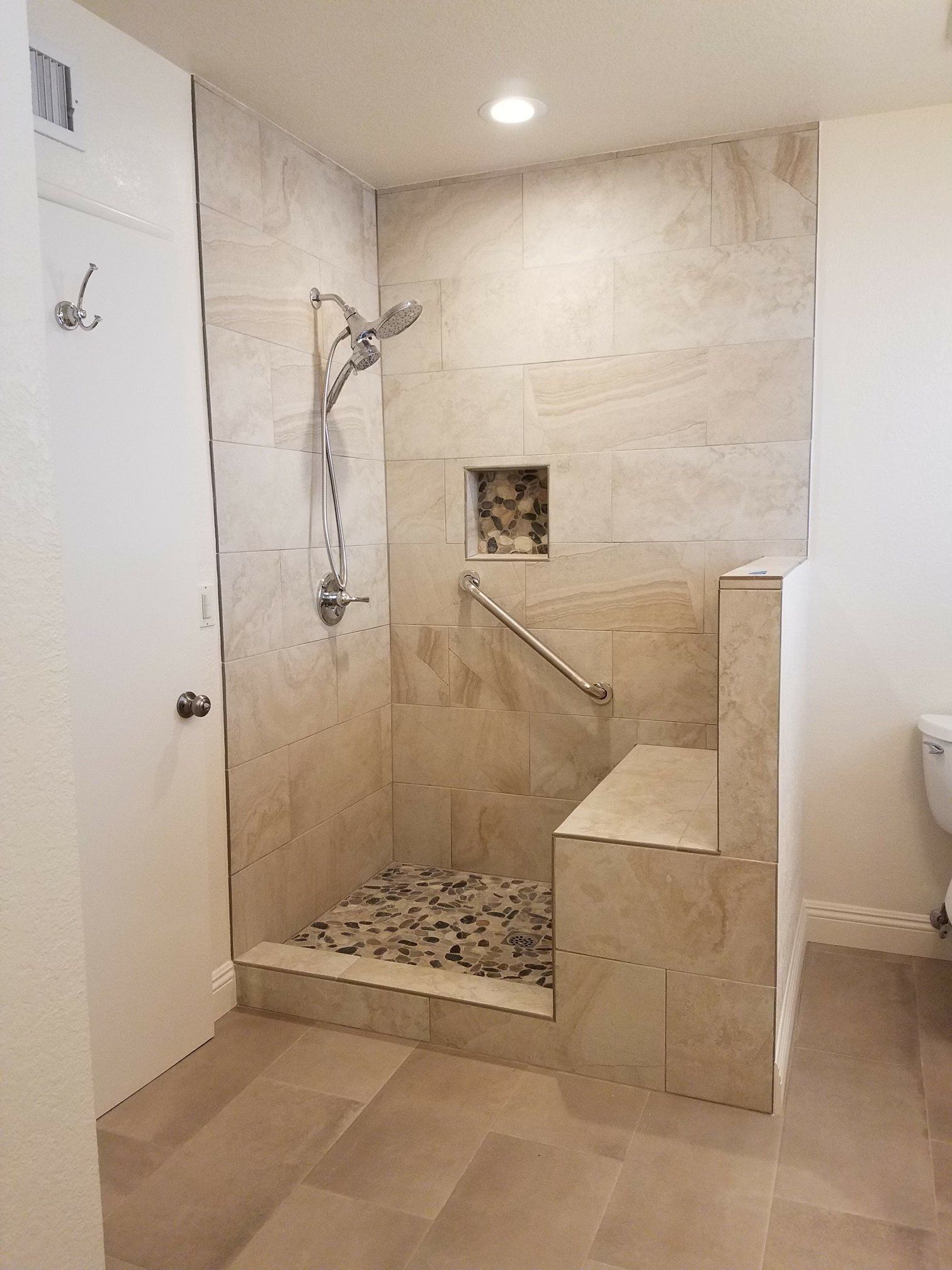 A bathroom with a walk in shower and a toilet.