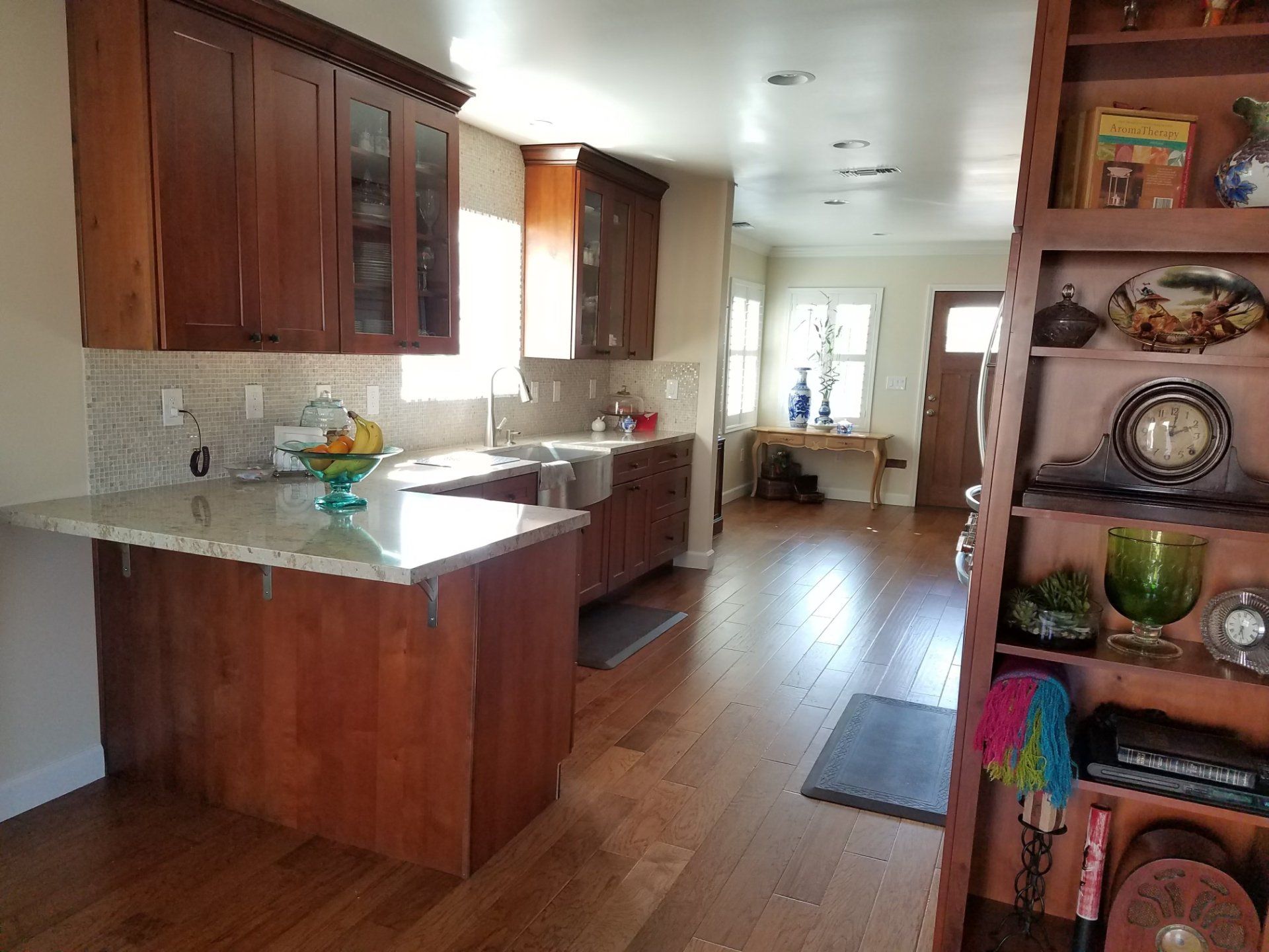 A kitchen with wooden cabinets and a granite counter top