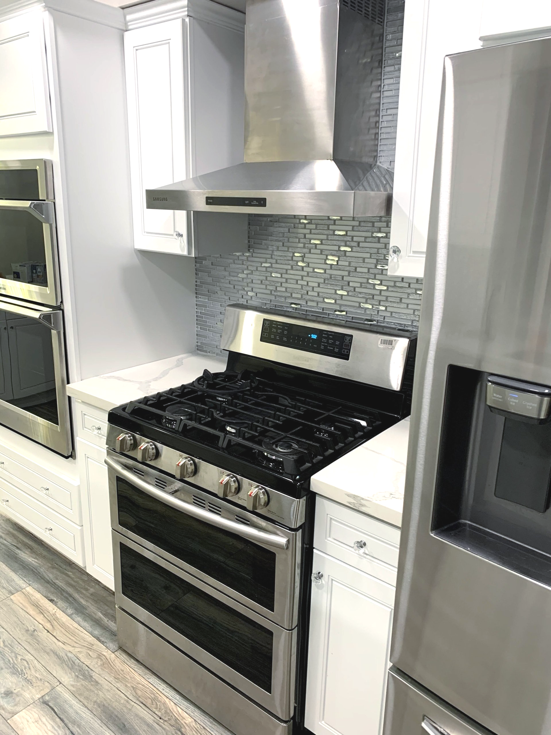 A kitchen with a stove , refrigerator , and dishwasher.