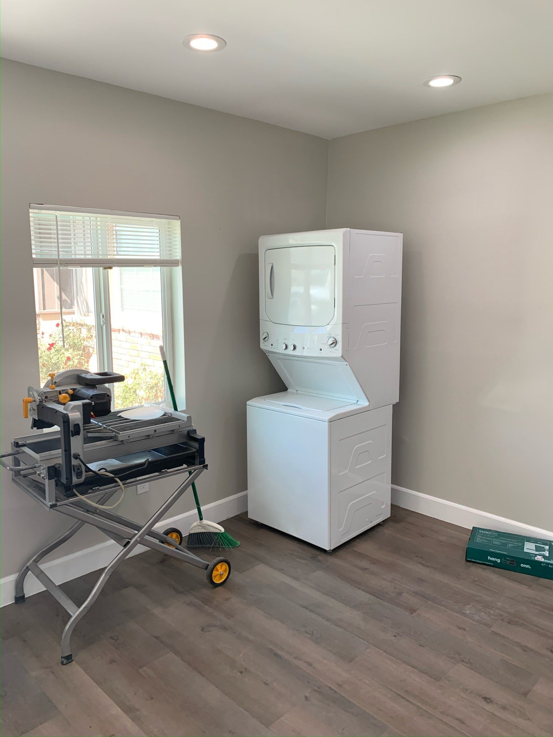 A laundry room with a washer and dryer and a window.