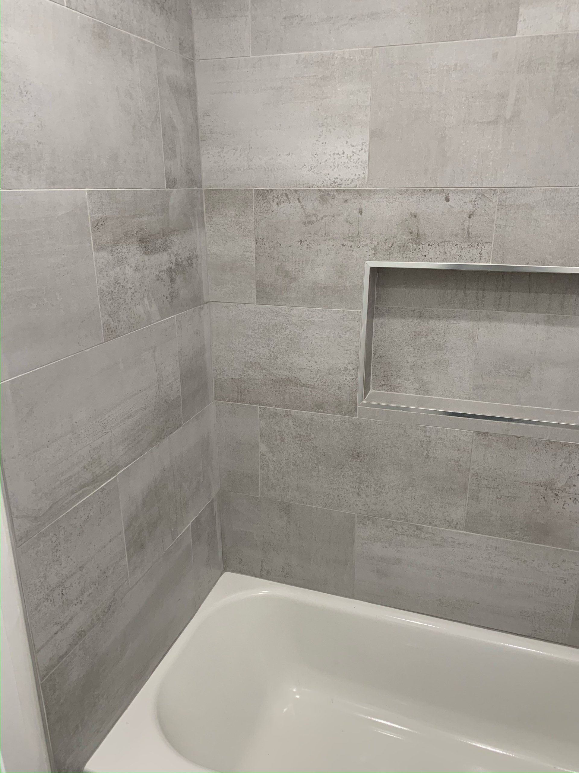 A bathroom with a bathtub and a shower.