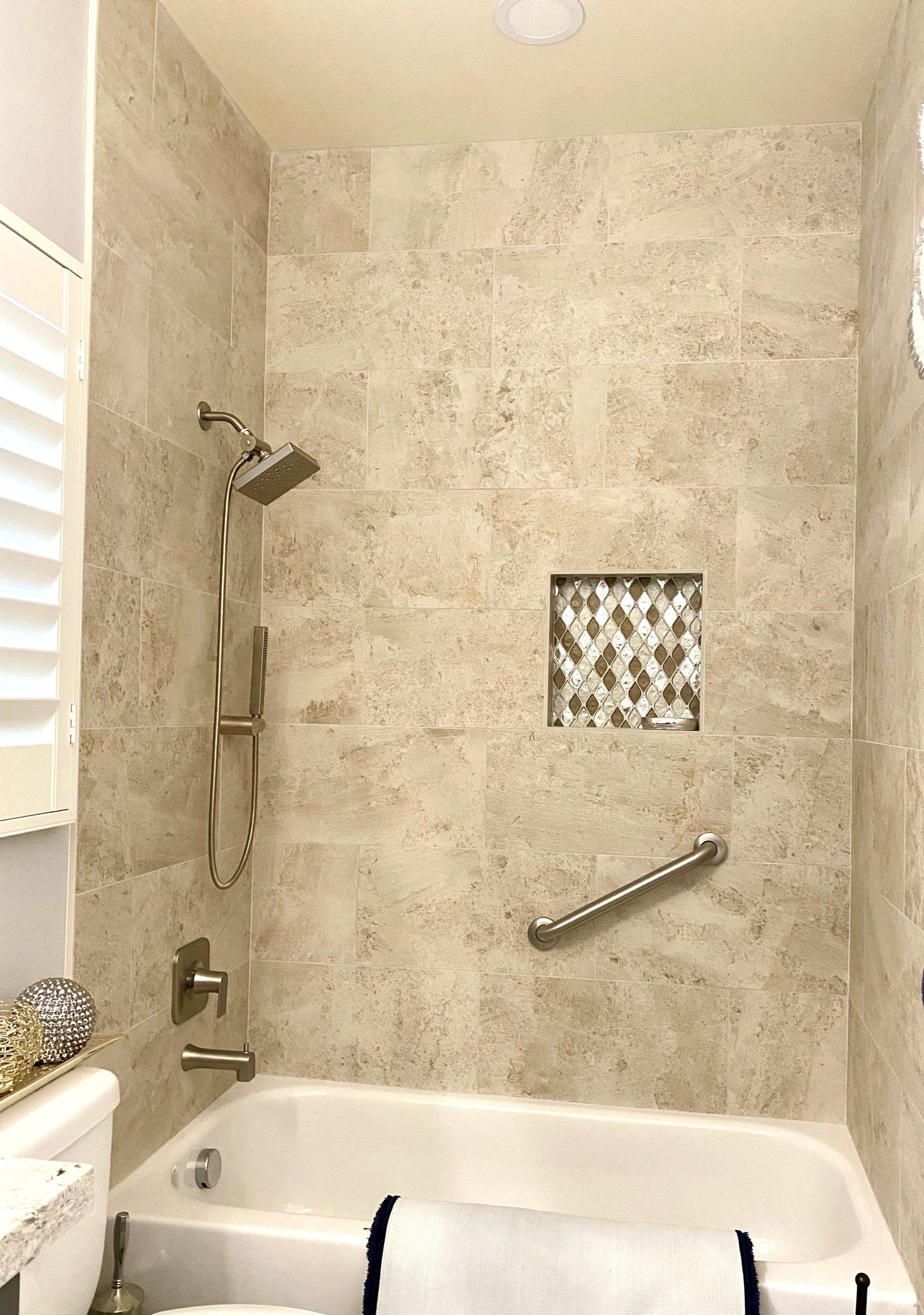 A bathroom with a tub , toilet and shower.