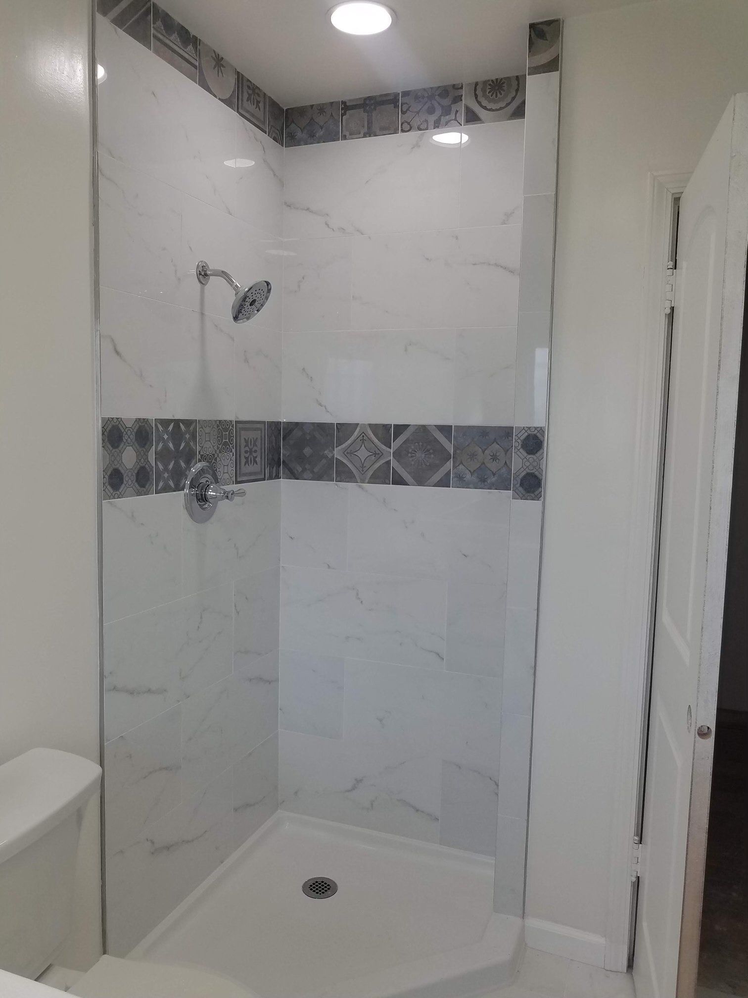 A bathroom with a walk in shower and a toilet.