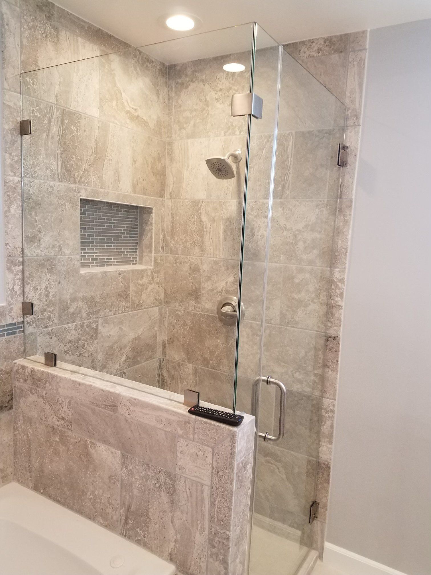A bathroom with a walk in shower and a bathtub.