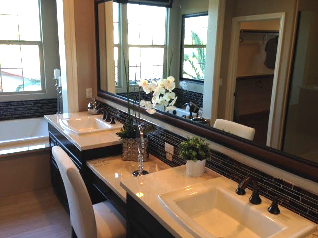 A bathroom with two sinks and a large mirror