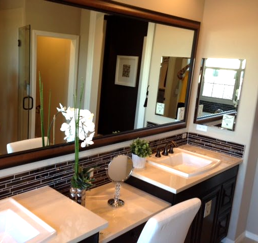 A bathroom with two sinks and a large mirror