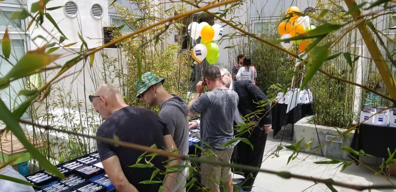 Person trying on glasses at Raise Your Glasses 2019 Event