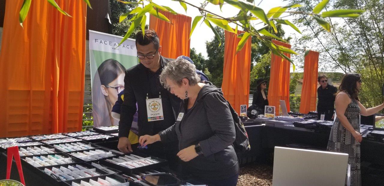 Vendor and shopper talking about frames at Raise Your Glasses 2019 Event