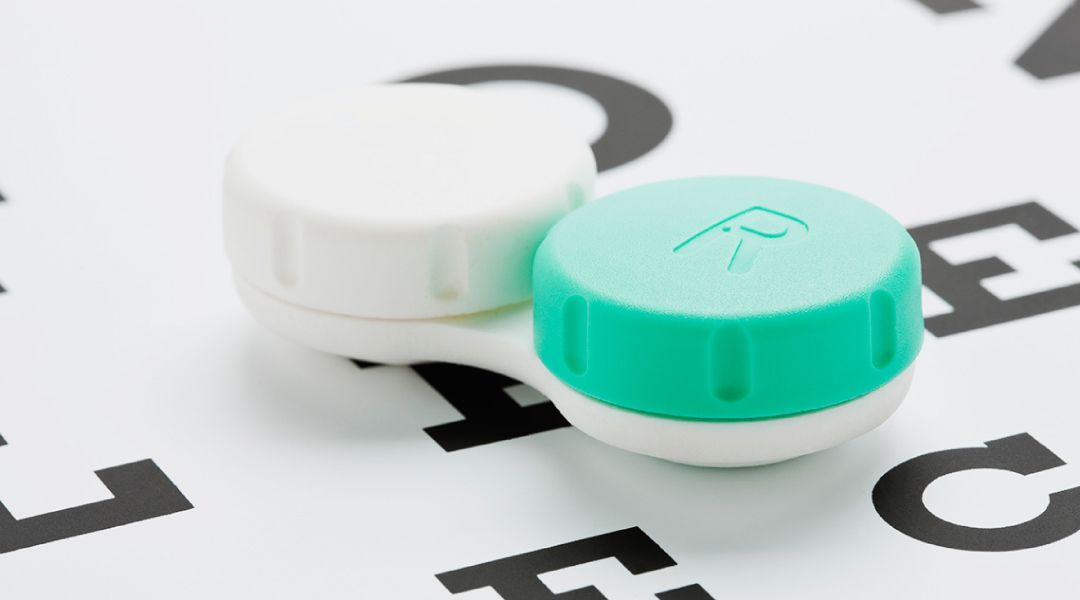 A contact lens case sitting on top of an eye chart