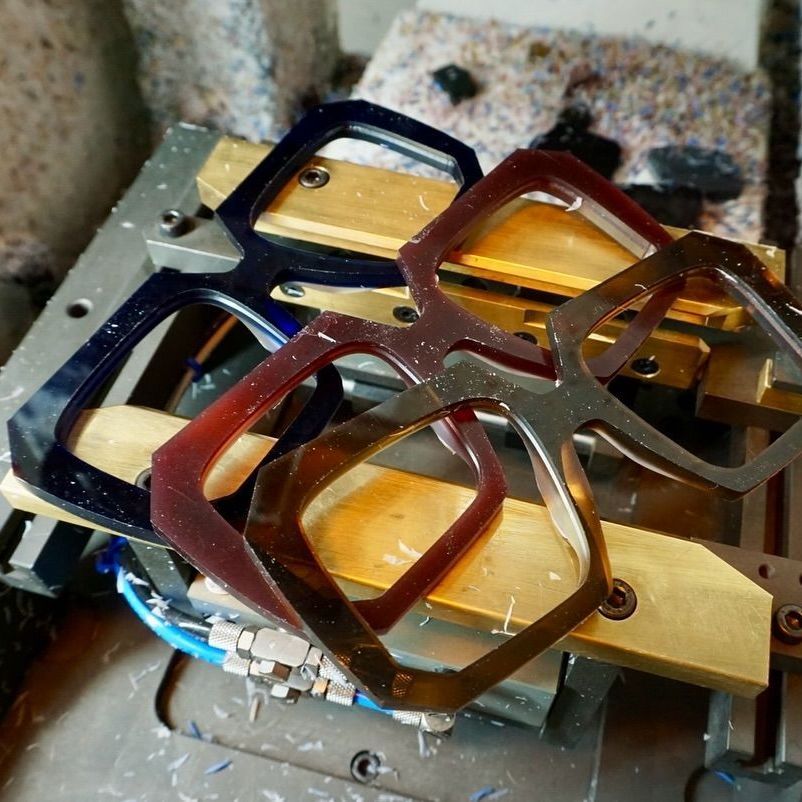 3 unfinished frame fronts  are stacked on top of each other on a workbench
