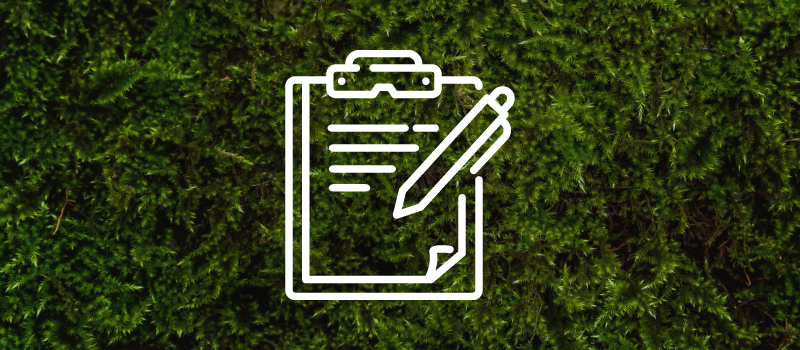 A line drawing of a clipboard with a pen on it on a green moss background
