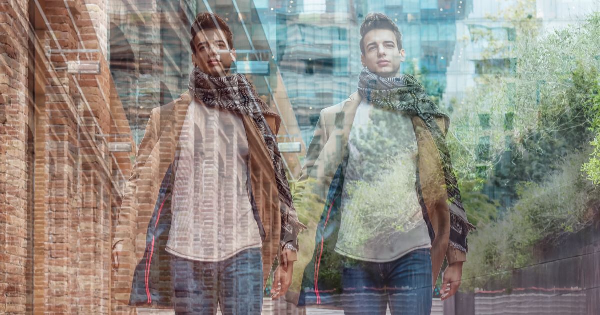 A double exposed image of a man walking down the street.