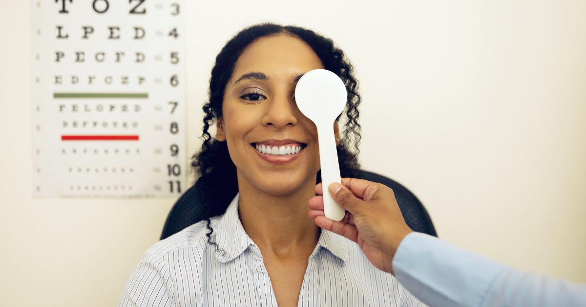 A woman is getting her eyes checked by an optometrist.