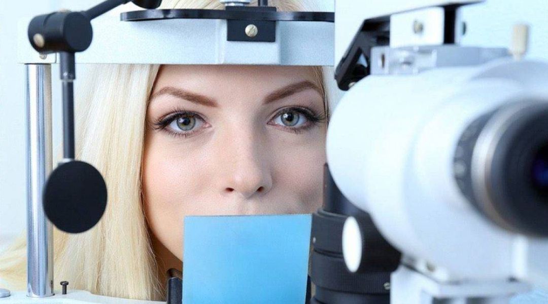 Close up of a woman with her head in an eye testing device