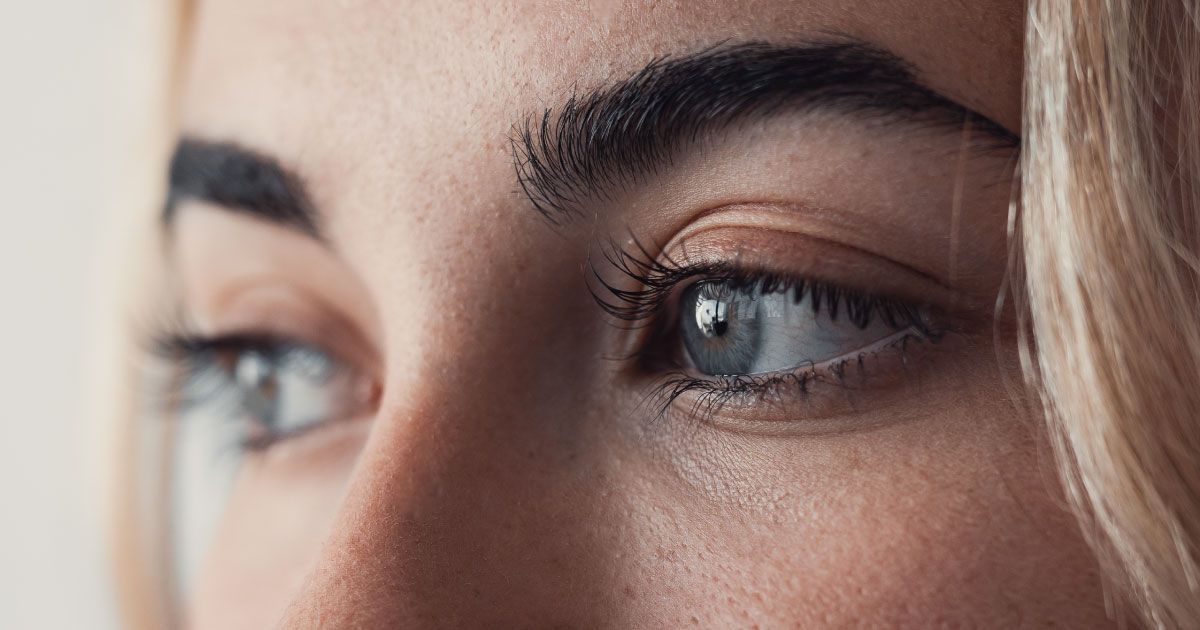 A close up of a woman's eyelashes and eyebrows.