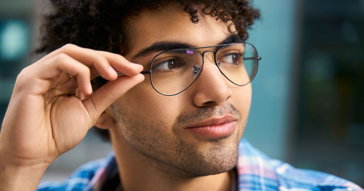 A close up of a man wearing glasses.
