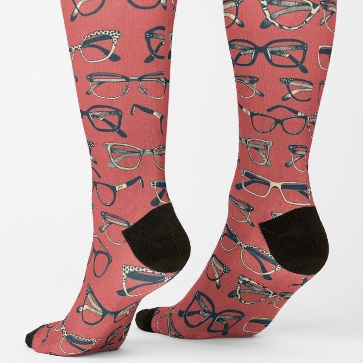 Pair of rose-colored socks with glasses printed all over them