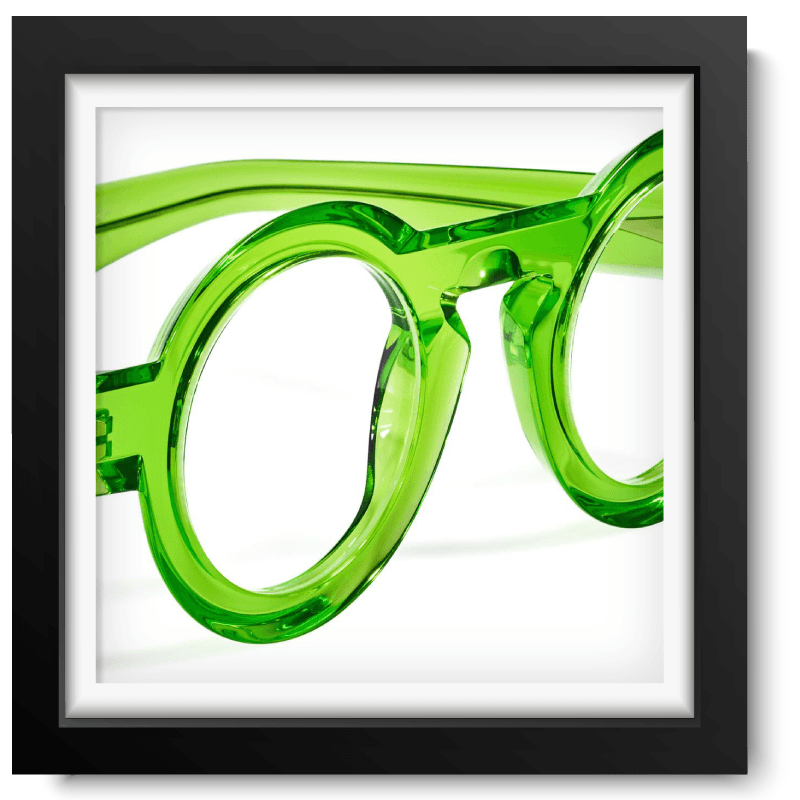 Black picture frame with a close-up picture of a lime green translucent glasses