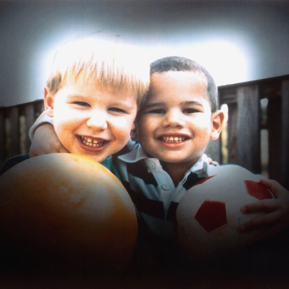 Slightly blurred image of two kids with rubber balls
