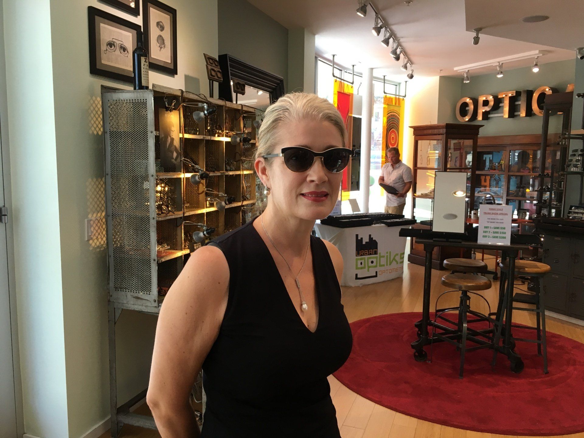 Person modeling sunglass frames at Gold & Wood and Tom Davies Trunk Show