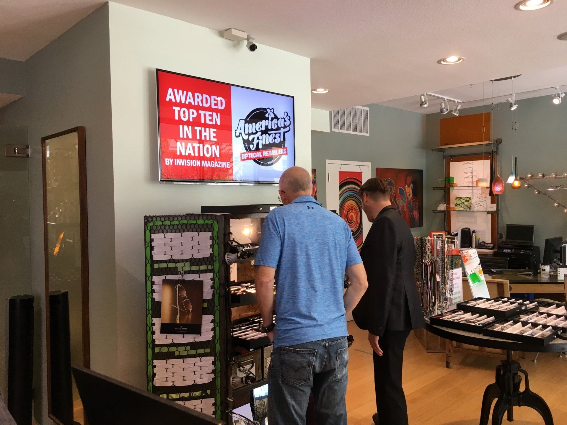 People looking at display cases at Gold & Wood and Tom Davies Trunk Show