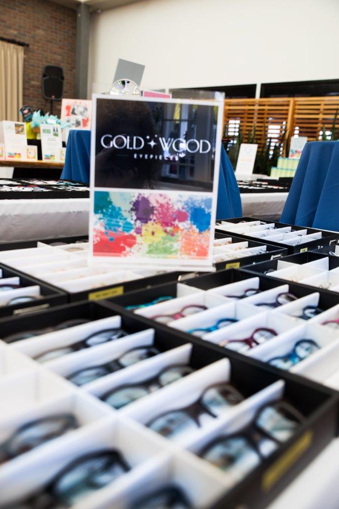 Gold and Wood sign and tabletop display  at 2018 Raise Your Glasses