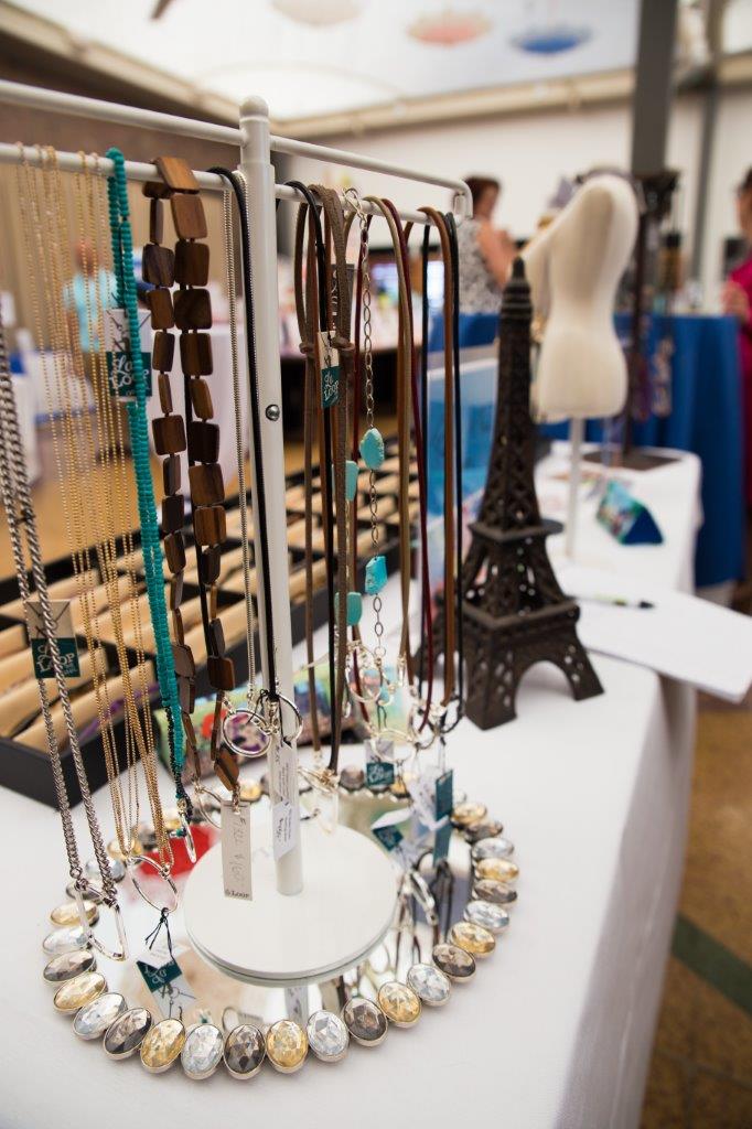 Many colorful eyewear accessories on tabletop display at 2018 Raise Your Glasses