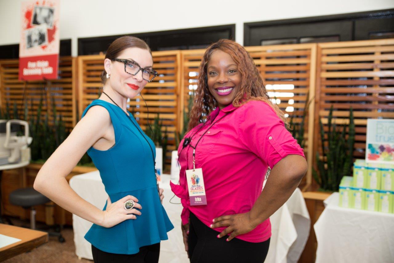2 staff members posing and smiling for camera at 2018 Raise Your Glasses