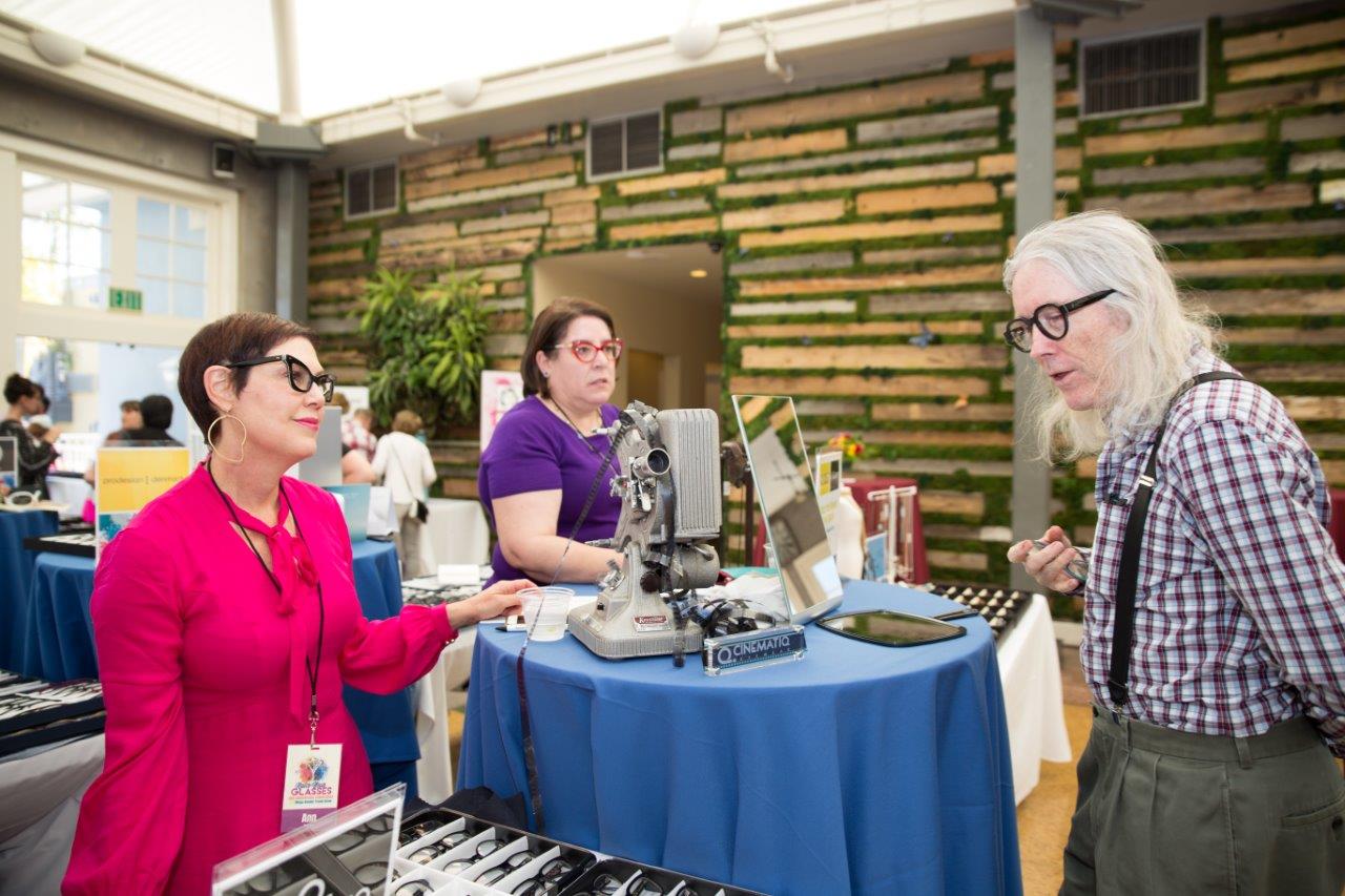 Vendors talking with guest at Raise Your Glasses 2018 Event