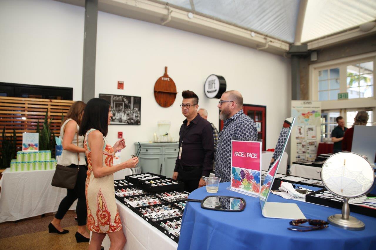 3 people chatting tabletop display at Raise Your Glasses 2018 Event