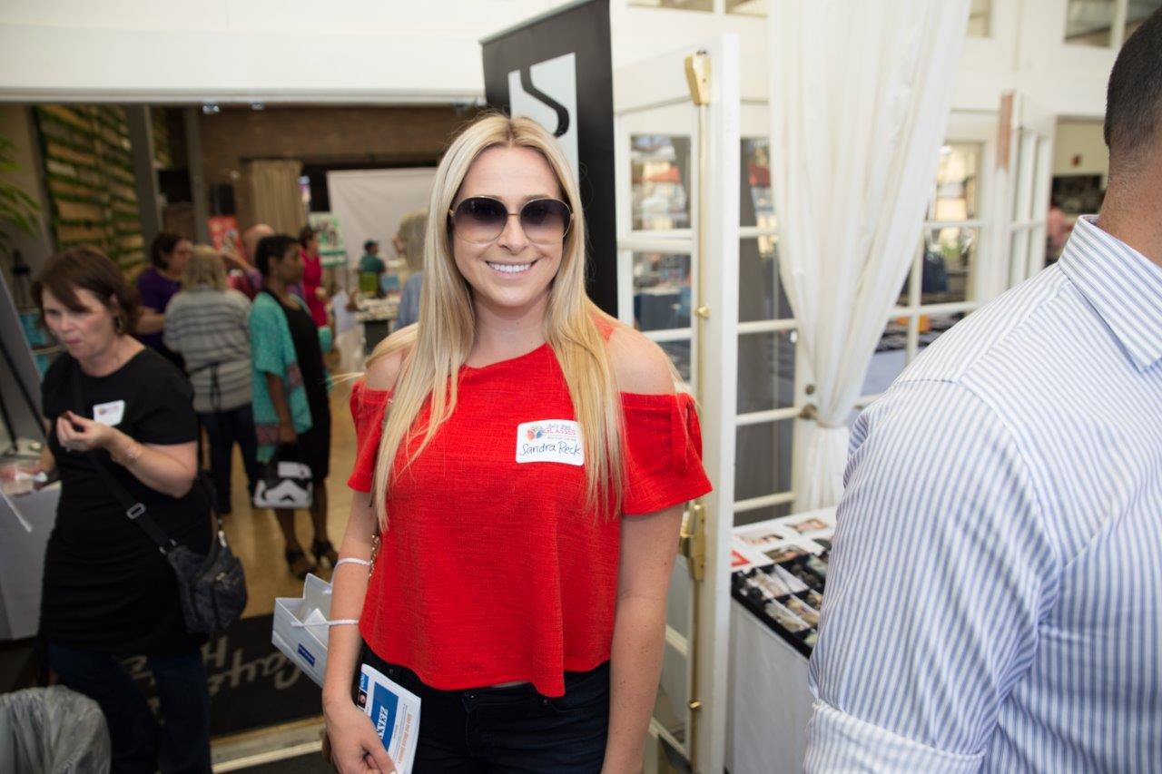 Guest in red blouse and sunglasses at Raise Your Glasses 2018 Event