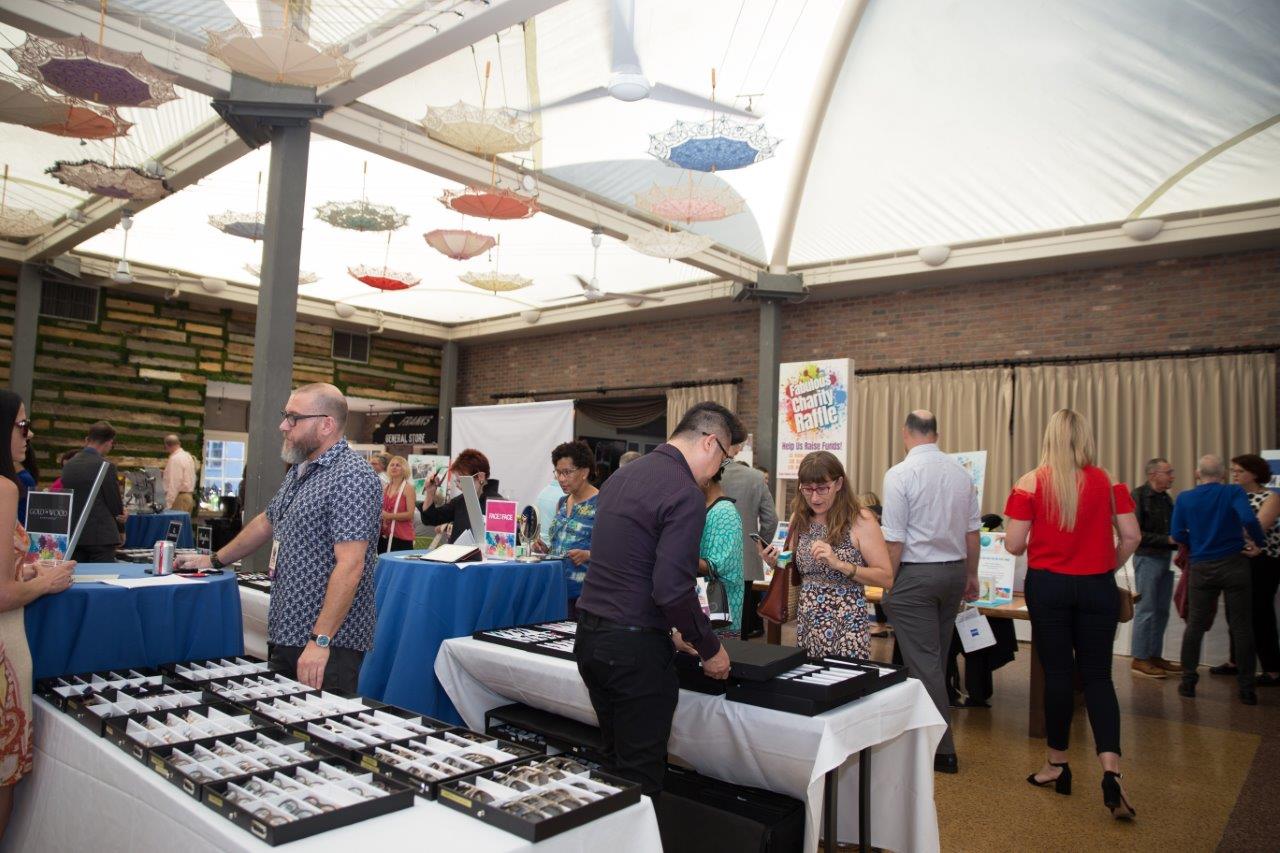 People looking at frames at Raise Your Glasses 2018 Event